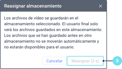 El cuadro de diálogo de confirmación 'Reasignar almacenamiento'. Muestra una advertencia de que los archivos existentes no se moverán automáticamente. La llamada 3 señala el botón 'Reasignar', que está temporalmente deshabilitado y muestra un temporizador de cuenta regresiva.